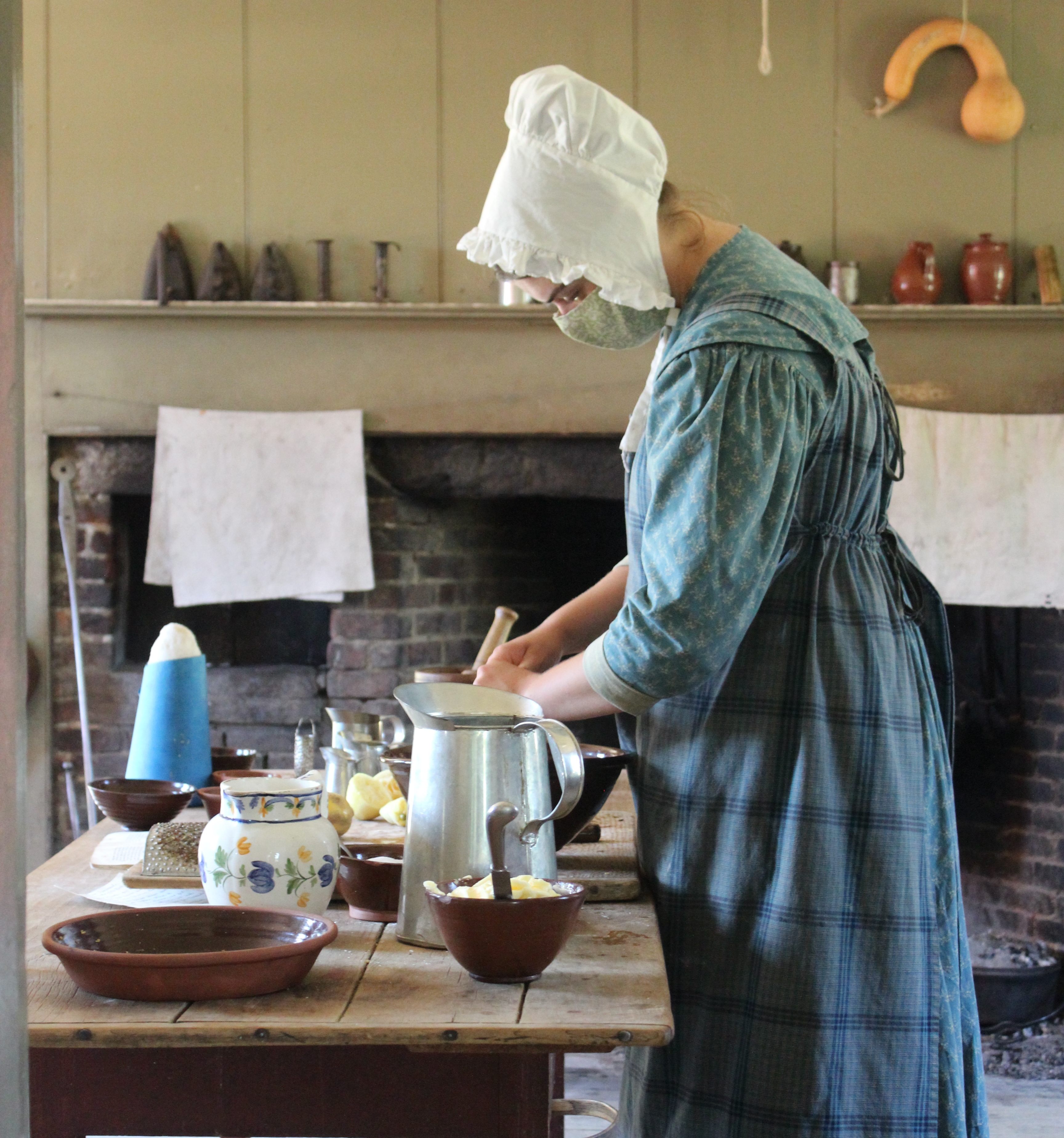 A costumed interpreter makes pies at Old Sturbridge Village.
