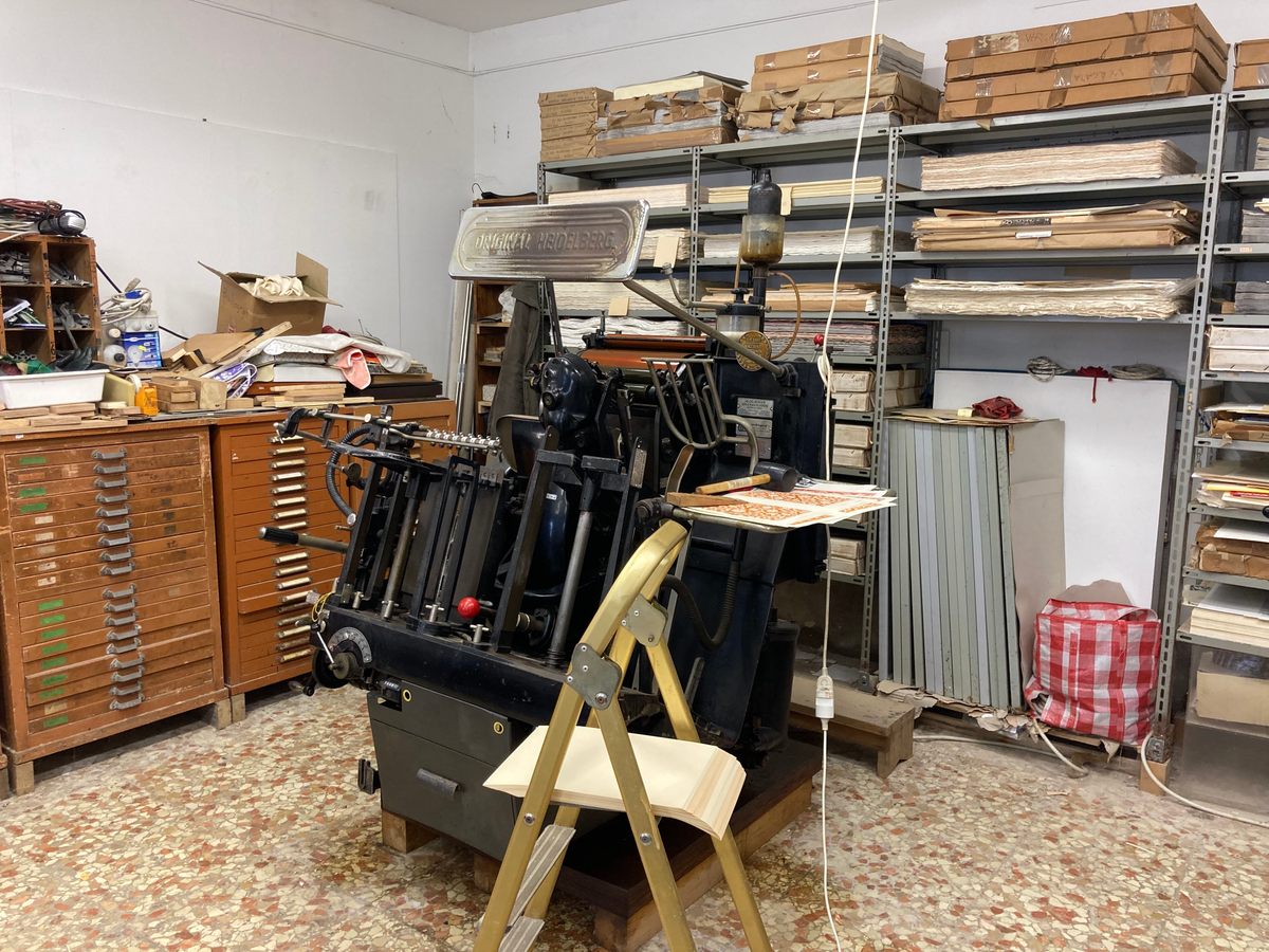 Olbi's workshop includes this 115-year-old manual printing machine.