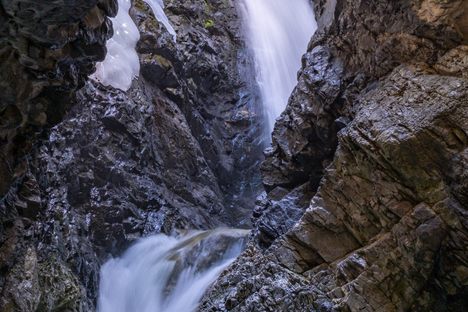 Zapata Falls in the San Luis Valley in Colorado. June 2023 photograph after relatively wet spring - some of the winter ice sheet is still present and visible in the upper left.