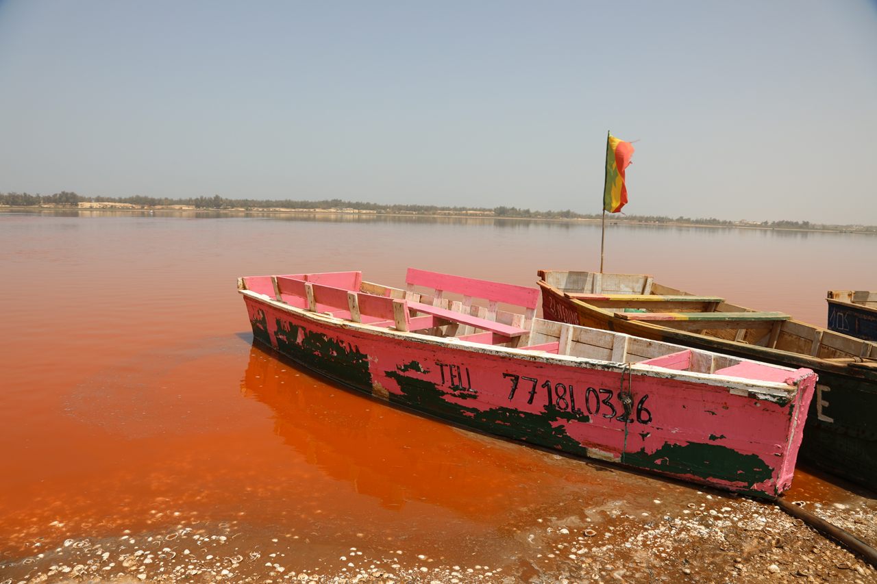 A pink boat for a pink lake. The water's color changes based on weather patterns and times of day. 