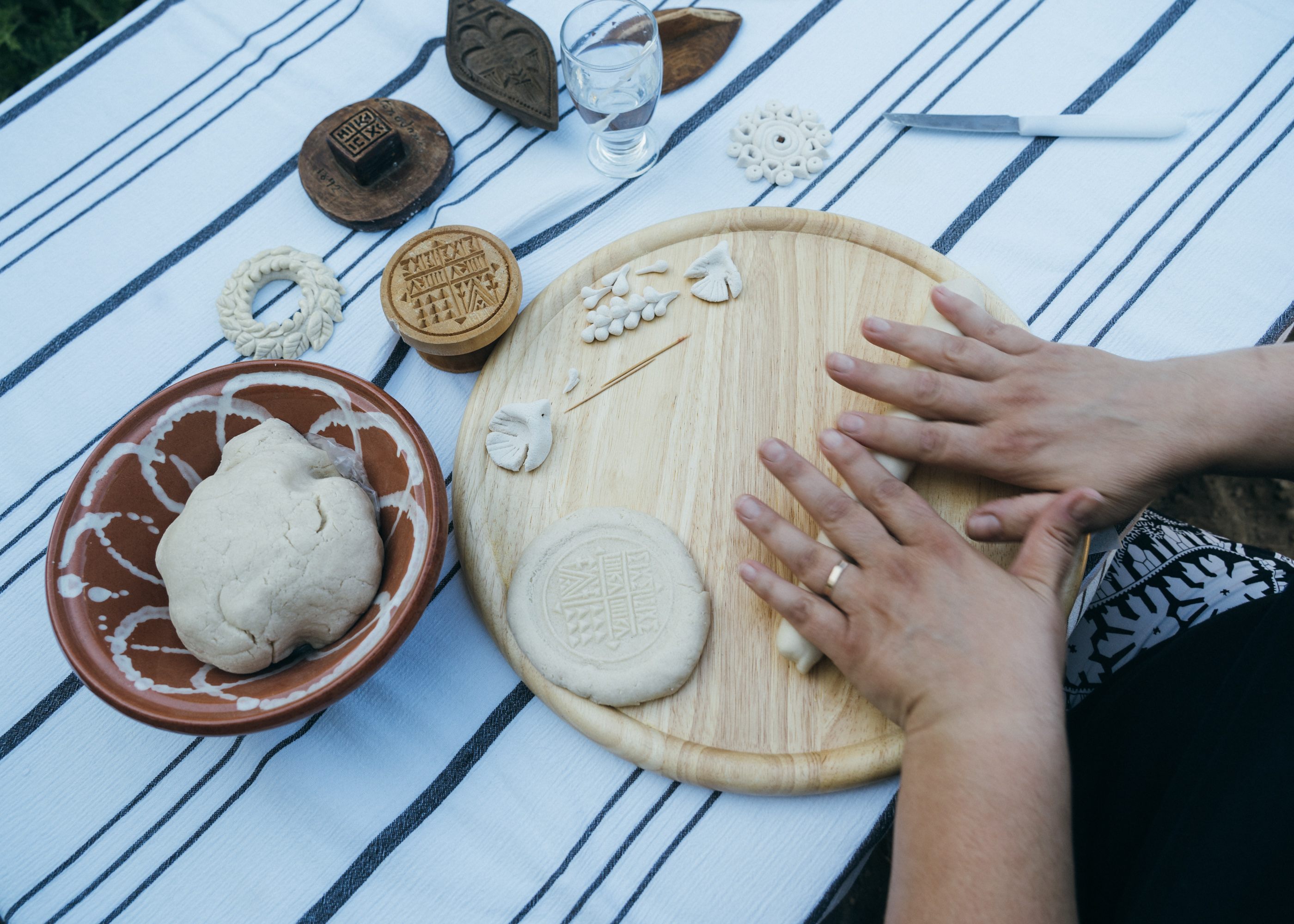 Giota Drakou prepares embroidered bread using molds and toothpicks. 