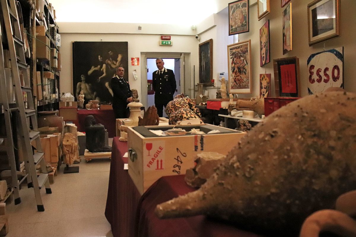 Alberto Deregibus and Nicola Candido of the carabinieri art squad in the vault. The Warhol on the right is fake.