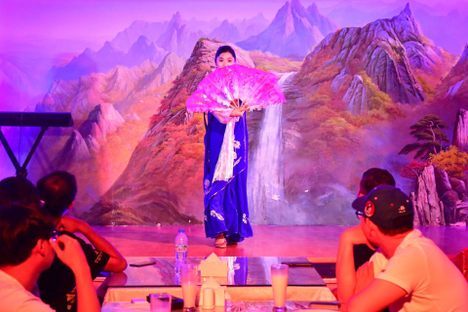 A crowd looks on as a performer takes the stage at Okryu-gwan.