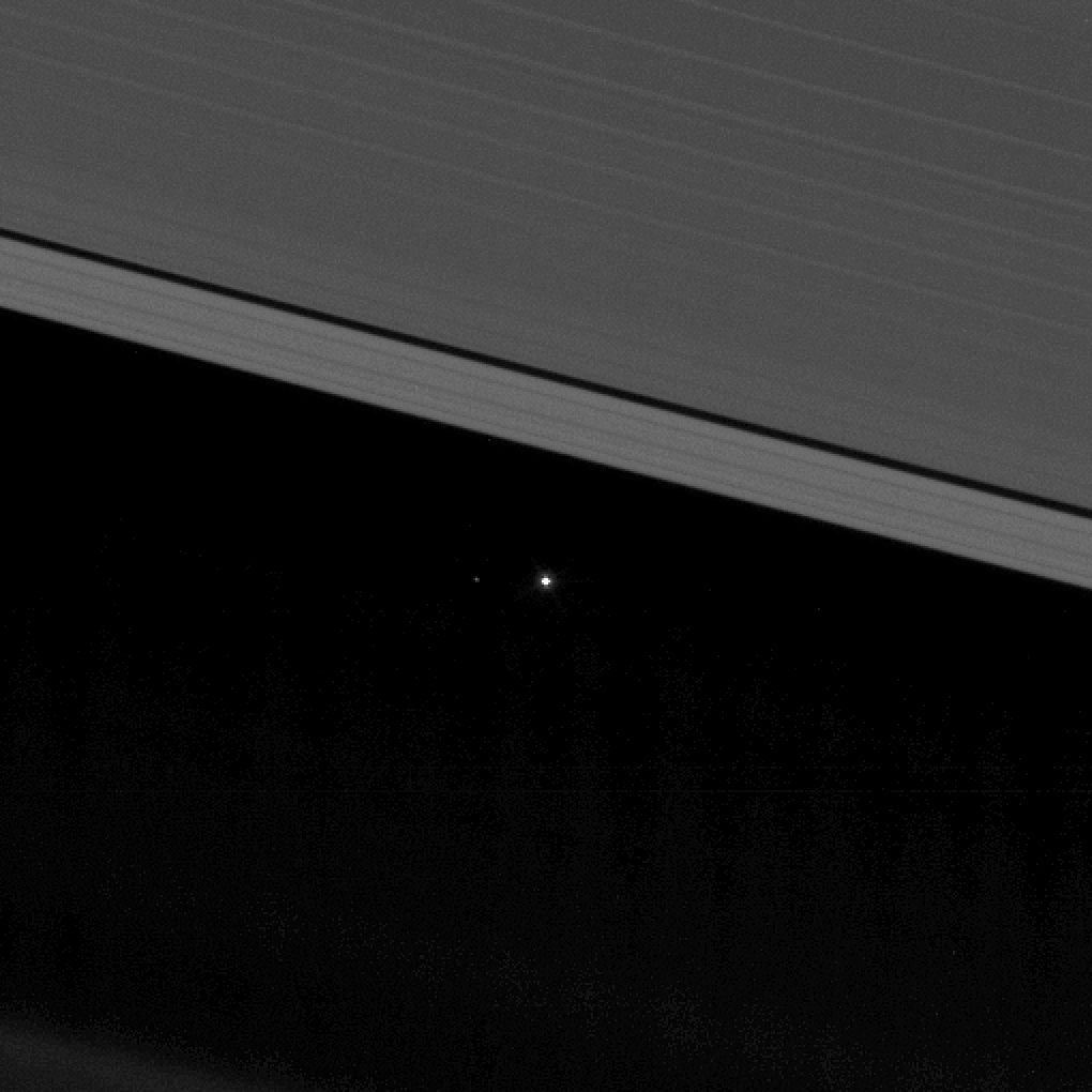Earth and the moon (on the left) from between Saturn's rings.