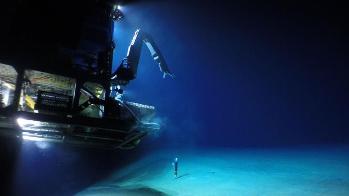 A remotely operated robot touches down on the seafloor to explore Havre.