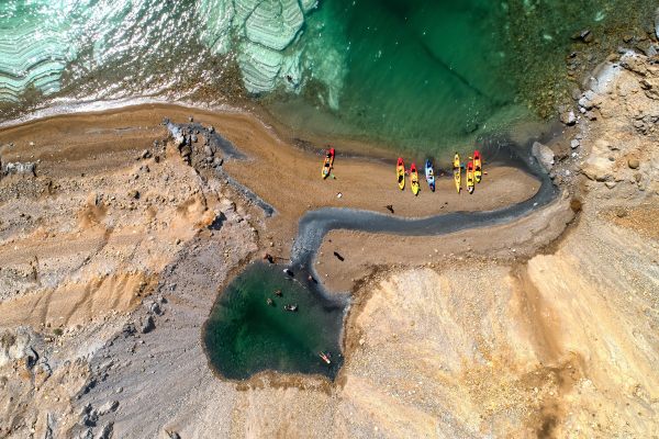 Kayakers visit a slumped sinkhole on the Dead Sea Coast. 