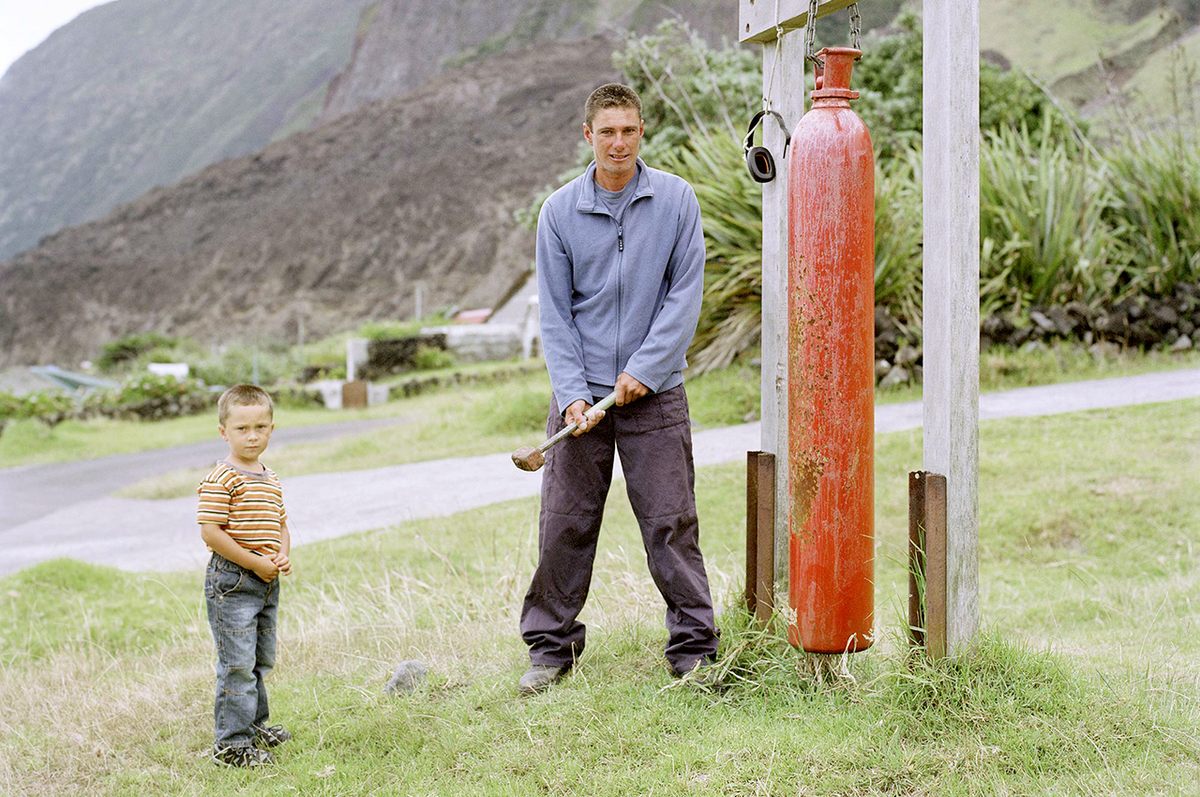 Nicky Swain and his son Ryan sound the island's dong.