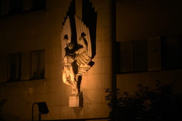 Icarus statue at night