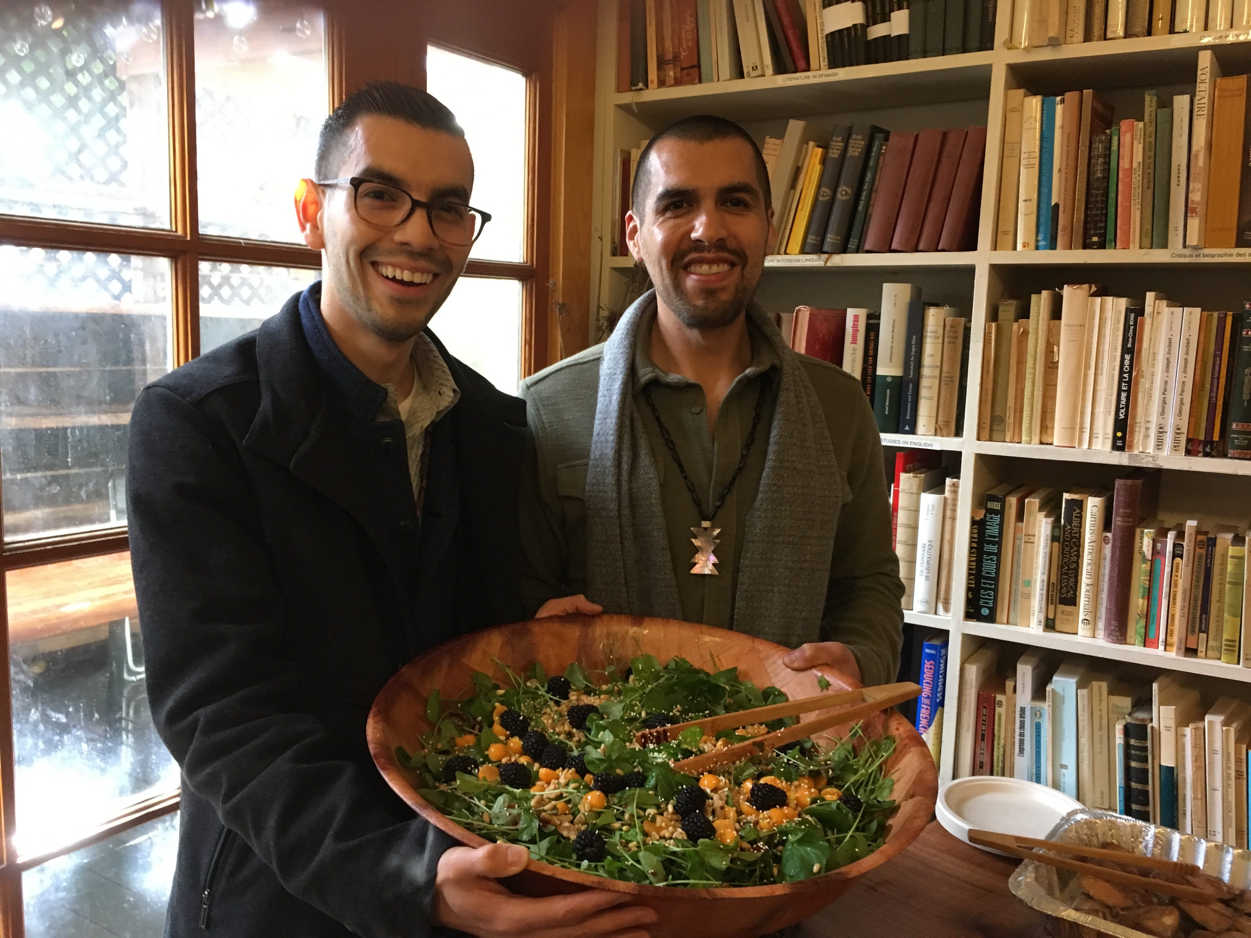 Trevino and Medina hold a salad of watercress, berries, and hazelnuts. 