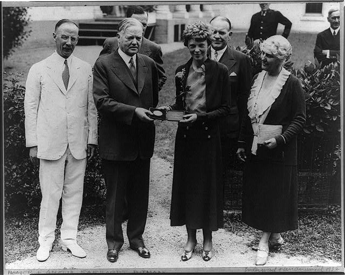 President Hoover presenting the National Geographic Society gold medal to Earhart recognition of her non-stop solo flight across the Atlantic Ocean