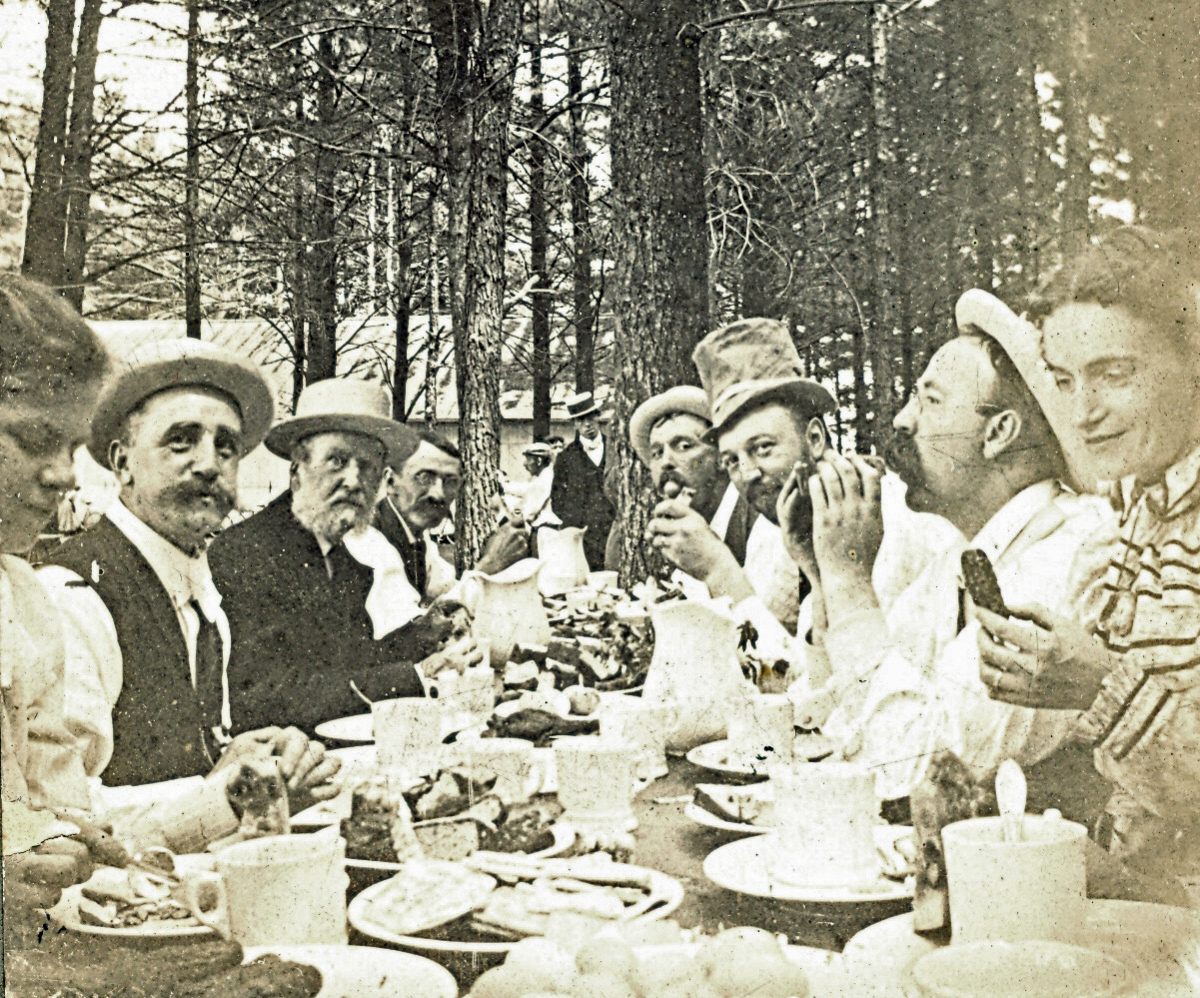Baker, the mustachioed gentleman second from the right, dines at one of his many opulent parties.