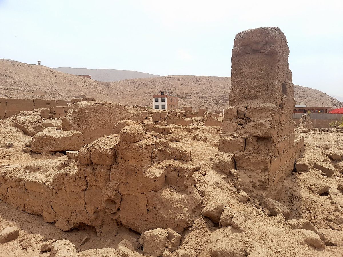 Homes illegally built on the site overlook parts of the ancient palatial complex.