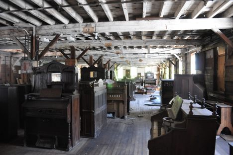 An old Estey Organ Company factory space filled with donated reed organs. 