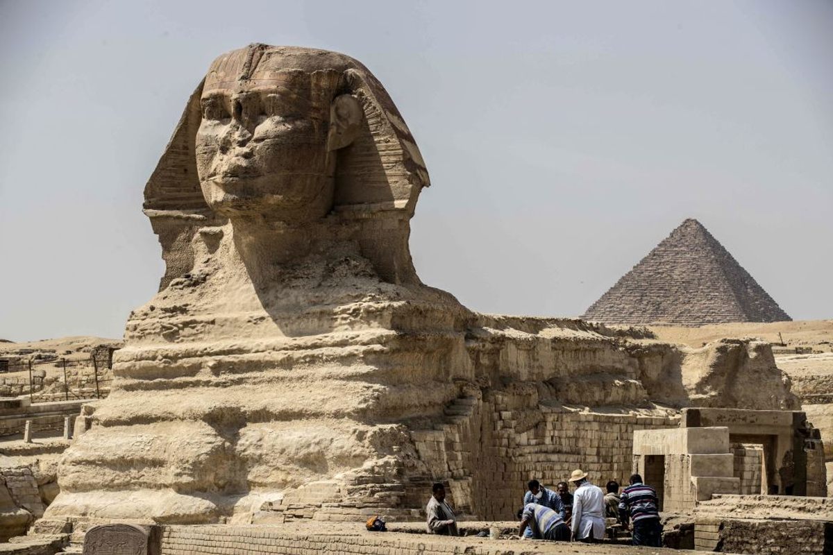 Archeologist work at the Giza pyramids necropolis near Cairo on March 25, after the site closed to the general public to slow the spread of COVID-19.