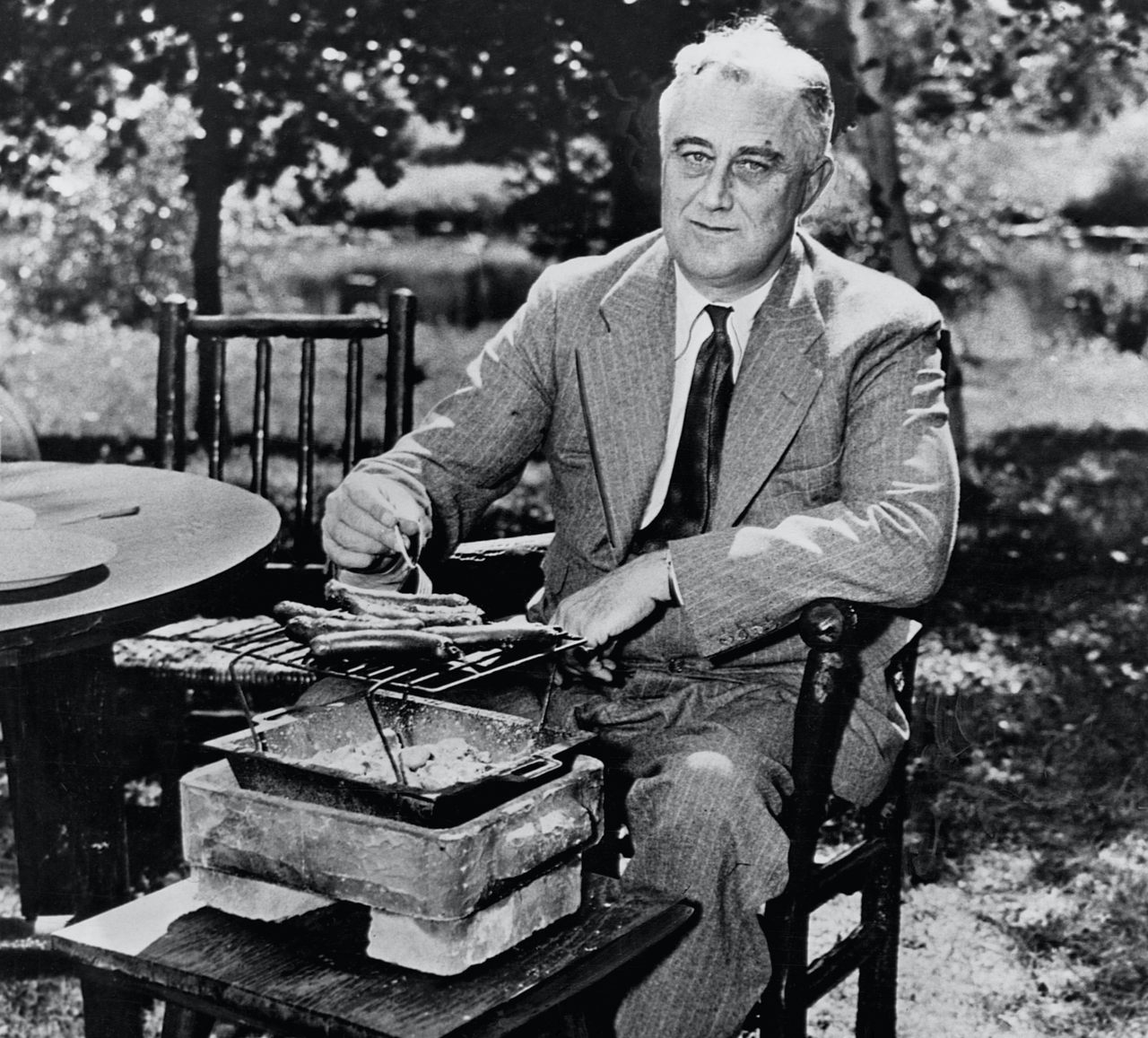 Franklin Delano Roosevelt roasting hot dogs. They smell like diplomatic breakthroughs.
