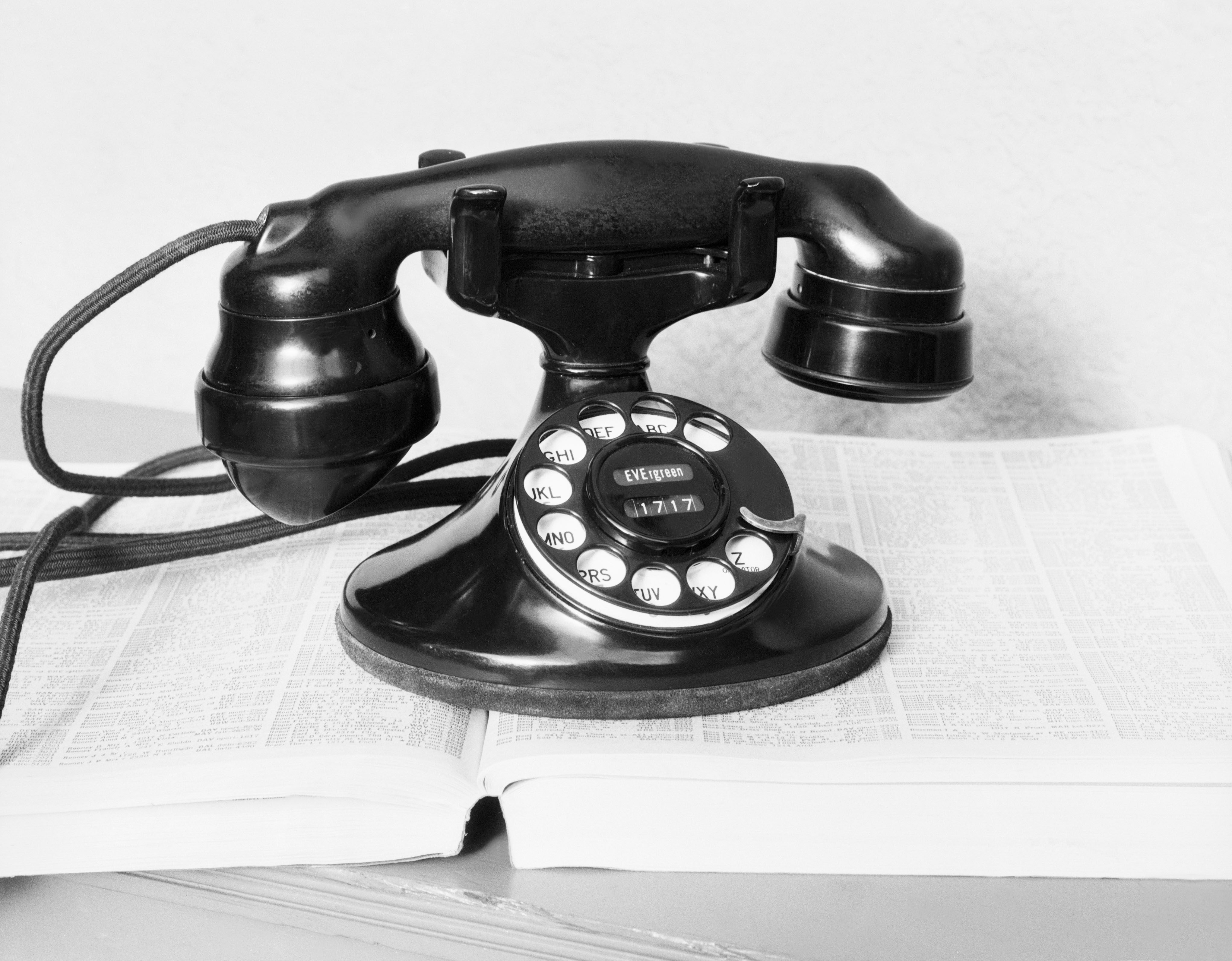 Details with a white old fashioned dial rotary phone from the