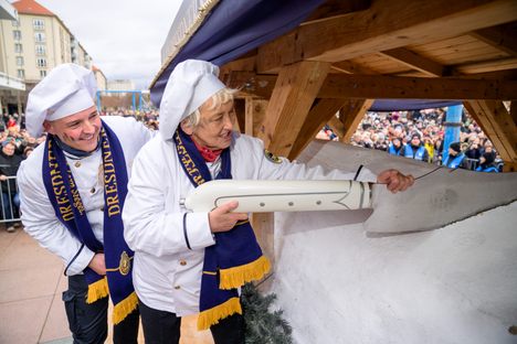 A local teacher saws away at this year's stollen.