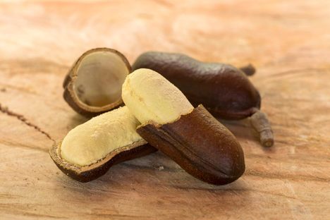 The hard brown exterior and cream-colored flesh of the stinking toe fruit.