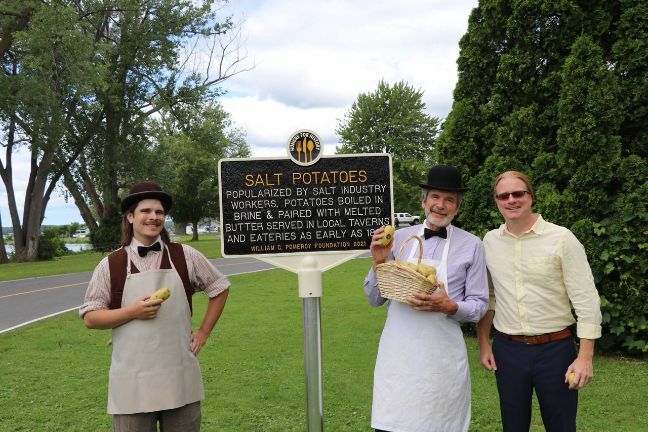 Local historian Robert Searing poses with the new plaque and period actors.
