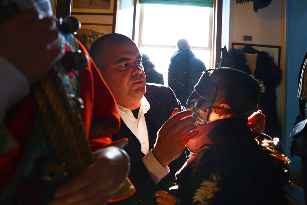 Italy, Sardinia, Ovodda. Man and woman wearing thick black face