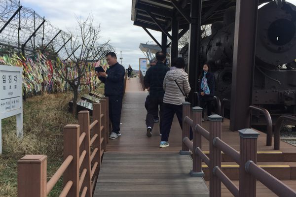 South Korean visitors often tie colored ribbons to nearby fences to remember loved ones across the border.