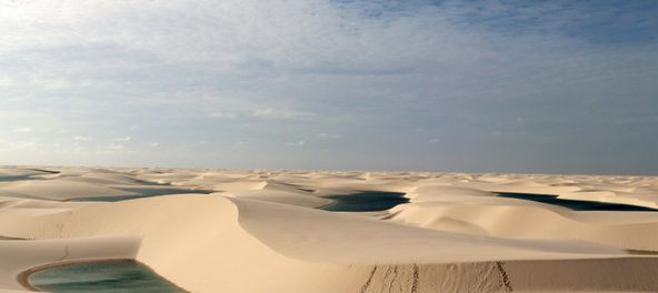 The rolling sand dunes of Lençóis Maranhenses in Brazil.