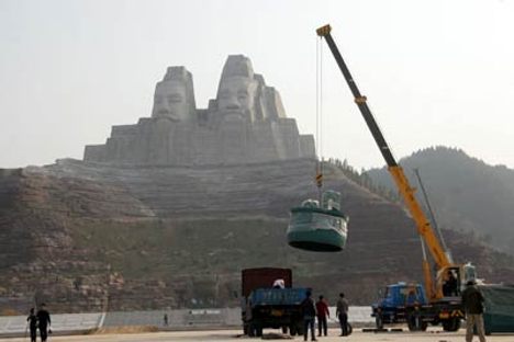 Cranes working below the statues