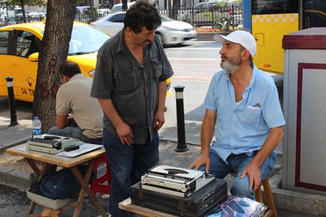 Scribe Adnan Gültek at his open-air office outside the social security building