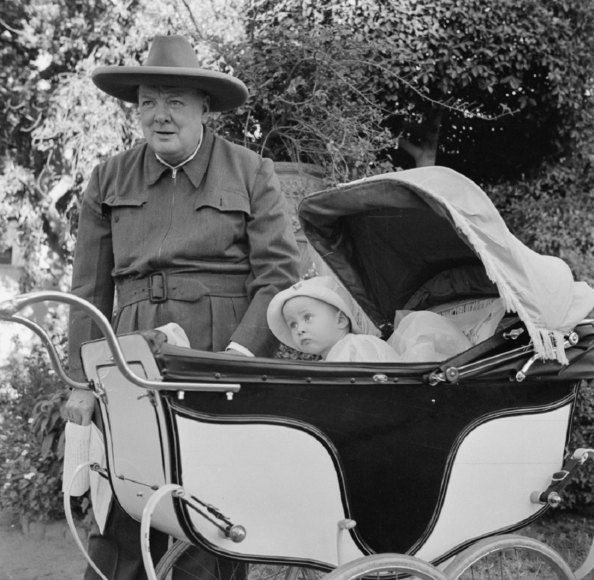 Winston Churchill in a siren suit, which he invented for warmth and modesty during nighttime raids.