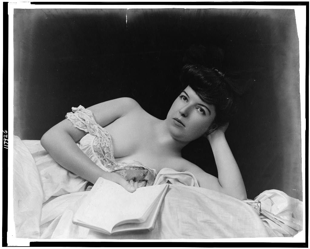 A photograph by F. W. Guerin from the turn of the century shows a woman holding a book.