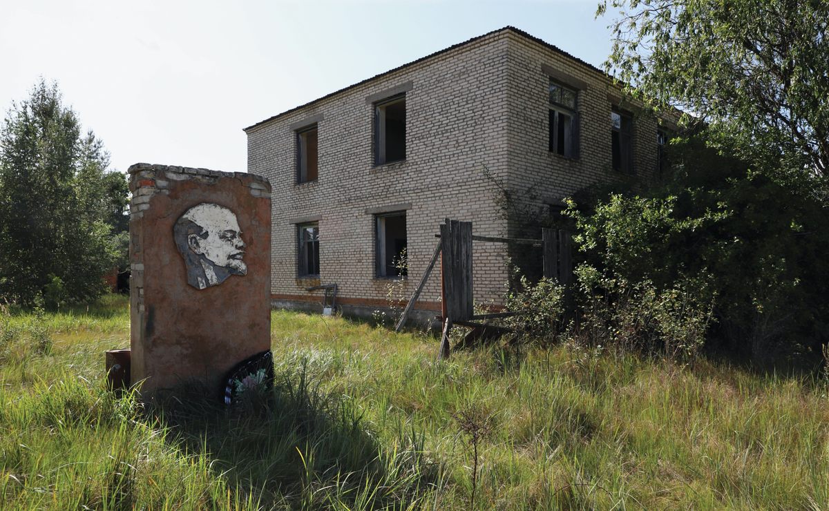 A Lenin monument outside a derelict administrative building in Arevichi, a village with 1,000 residents at the time of the disaster.