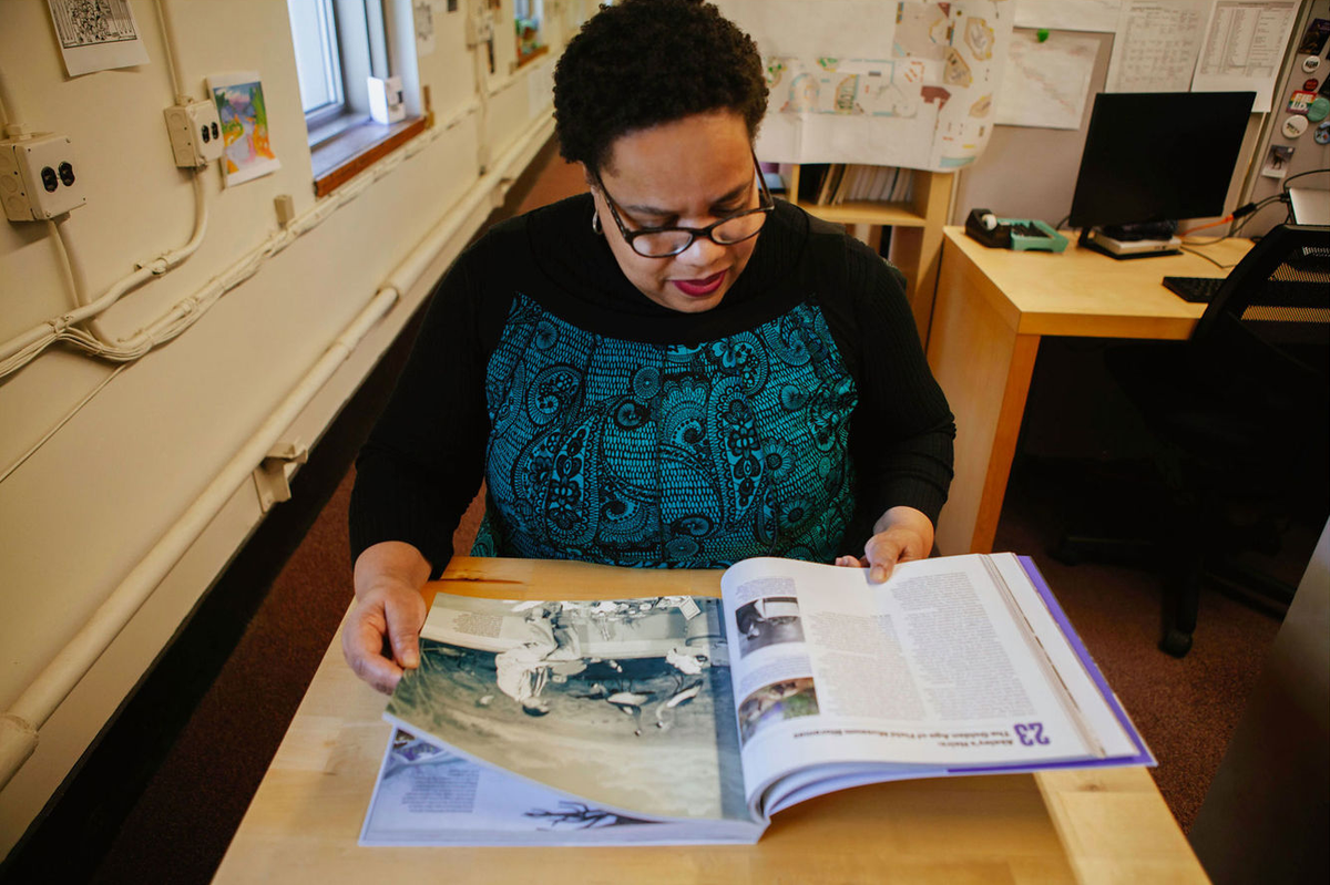 Reda Brooks, looking at the museum’s 125th anniversary book.