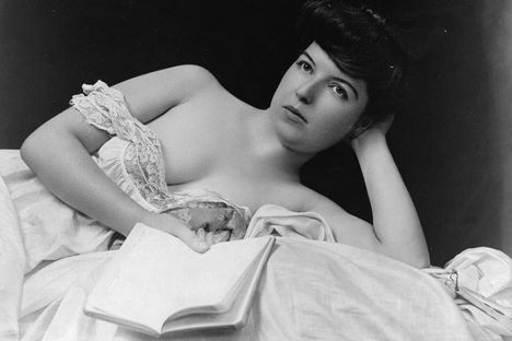A photograph by F. W. Guerin from the turn of the century shows a woman holding  a book.