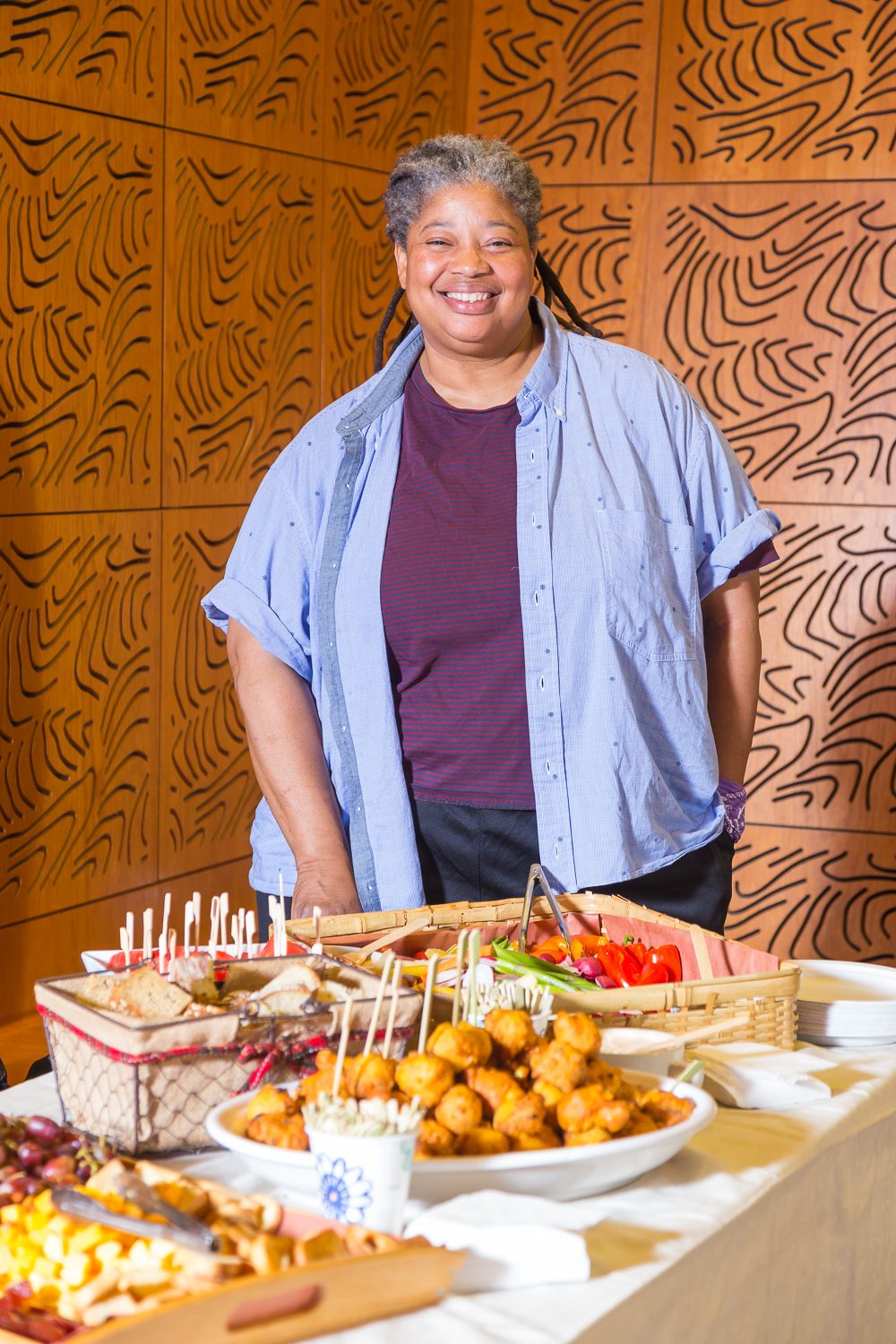 Chef Cheryl Smith stands with the Weeksville-inspired menu she created for the Meals as Collective Memory Community Dinner, May 2019.