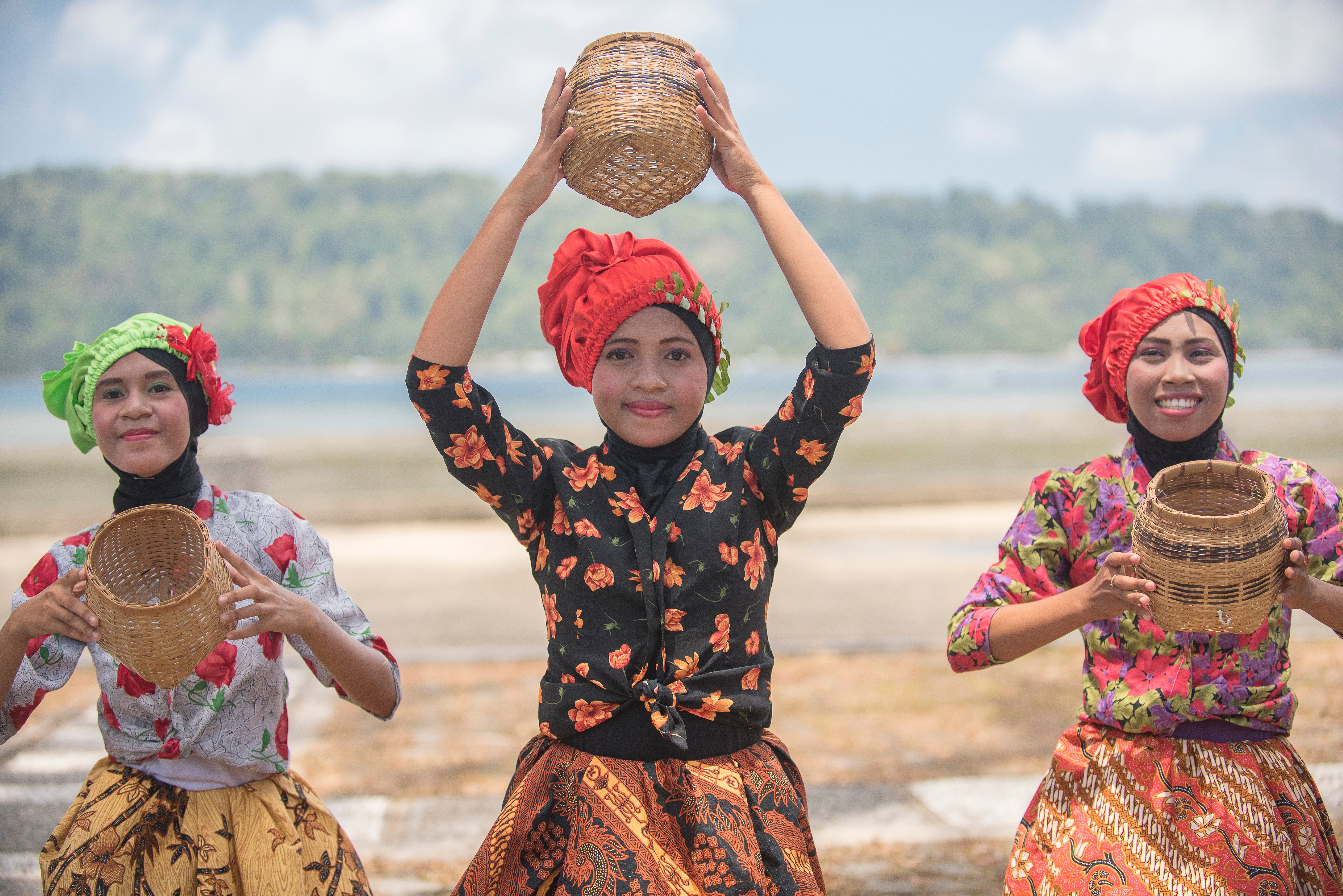 Young women perform a nutmeg picking dance on Banda Neira.
