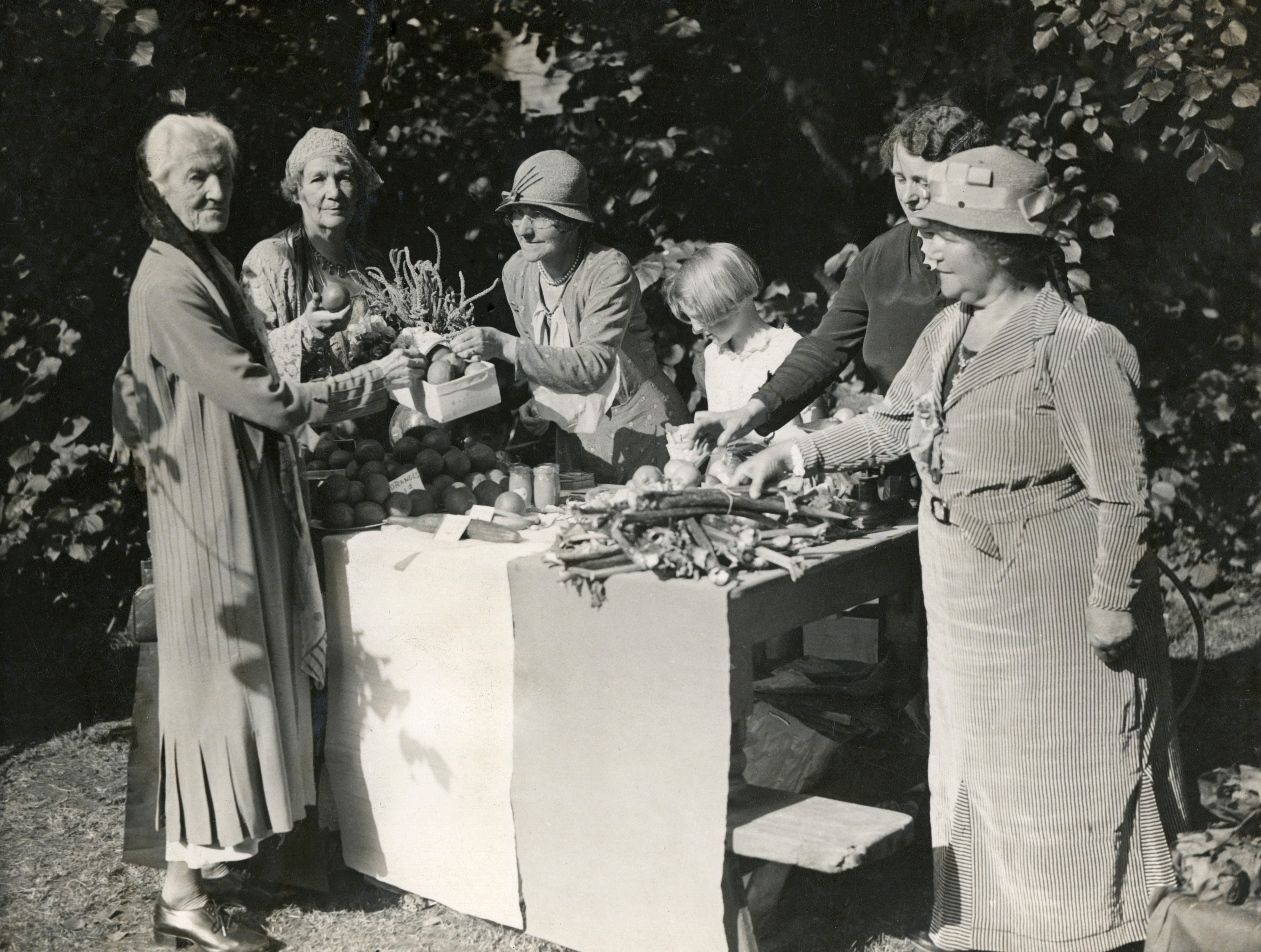 Suffragettes Charlotte Despard and Emmeline Pethick-Lawrence buy vegetables in the 1930s.