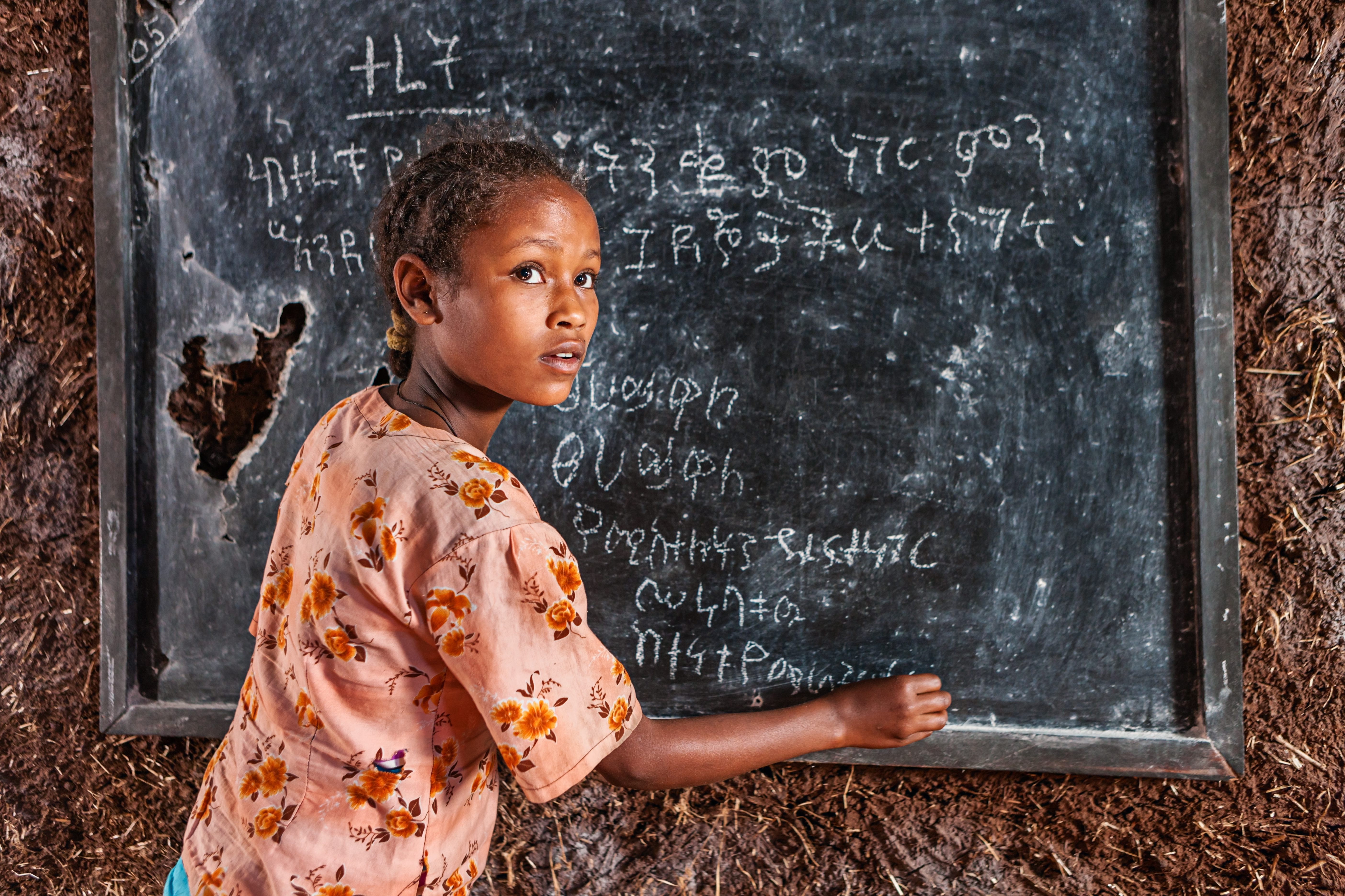 A girl in a remote school practices her Amharic. 