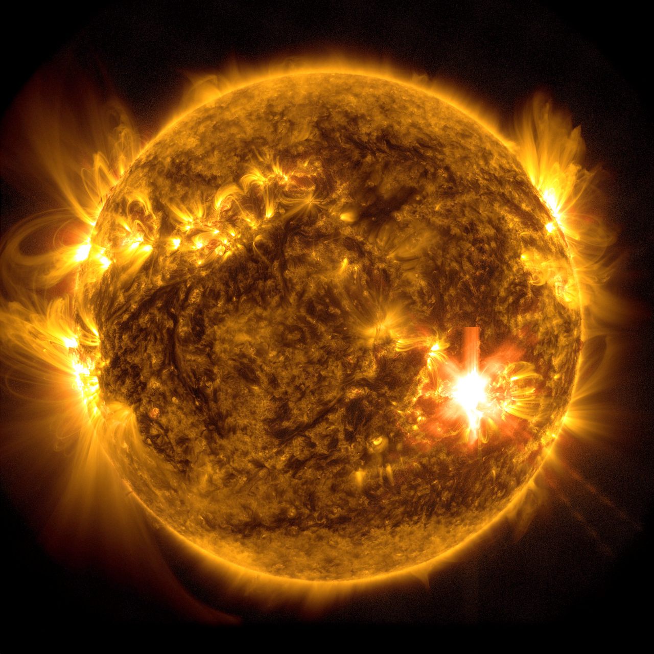 A powerful X3.9 solar flare, visible at lower right, erupts on May 10 in an image captured by NASA’s Solar Dynamics Observatory.