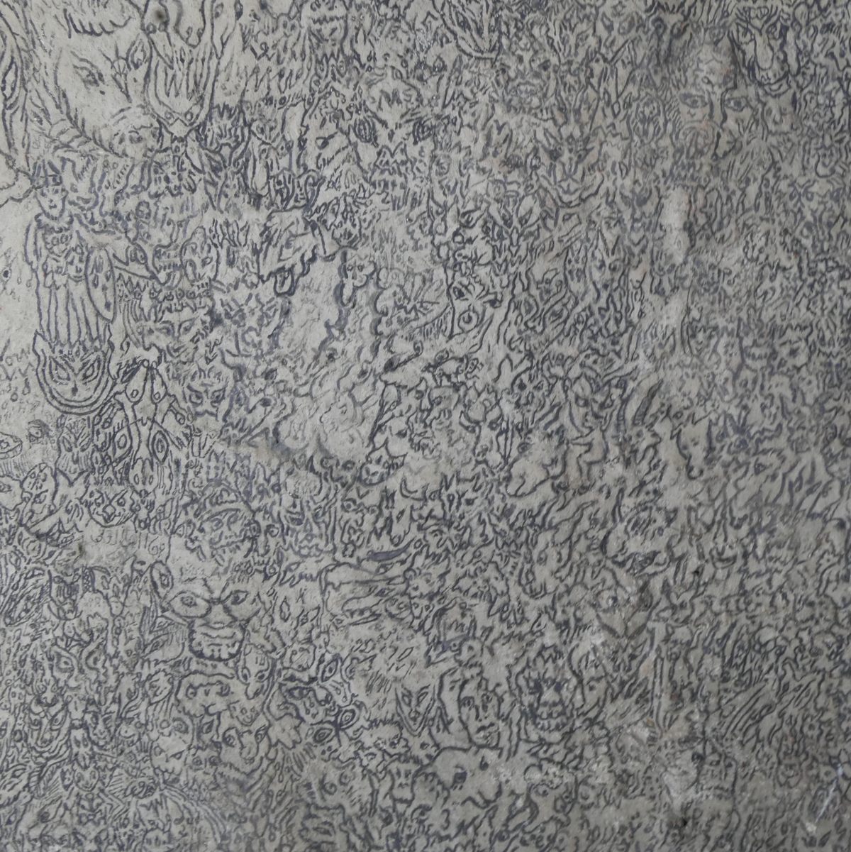 The demon wall's style exhibits horror vacui, an aversion to empty space typical of schizophrenic art.