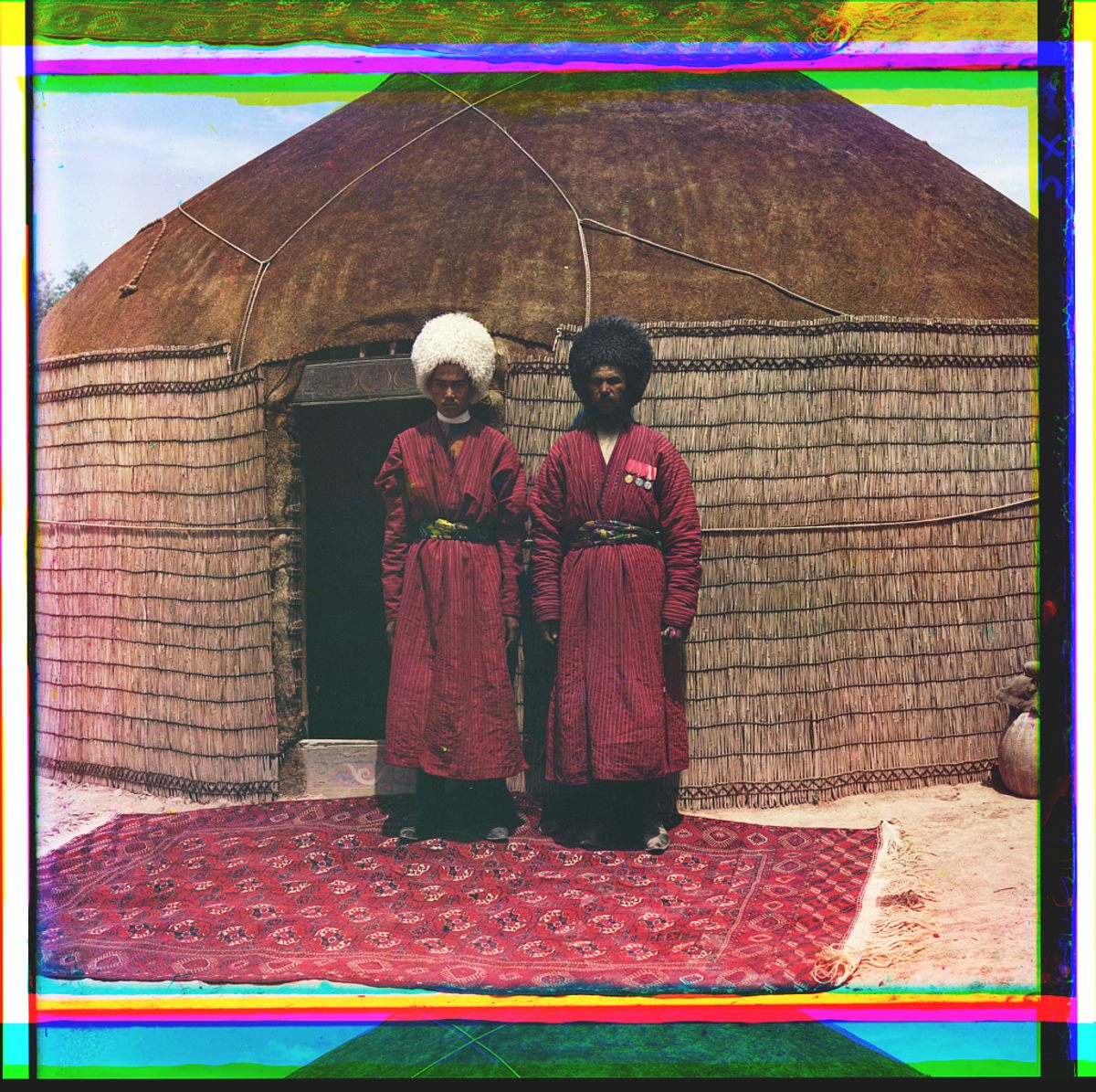 Two men in front of a yurt.