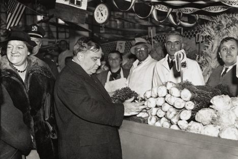 Mayor Fiorello LaGuardia examines produce at a stall several years after his artichoke war.