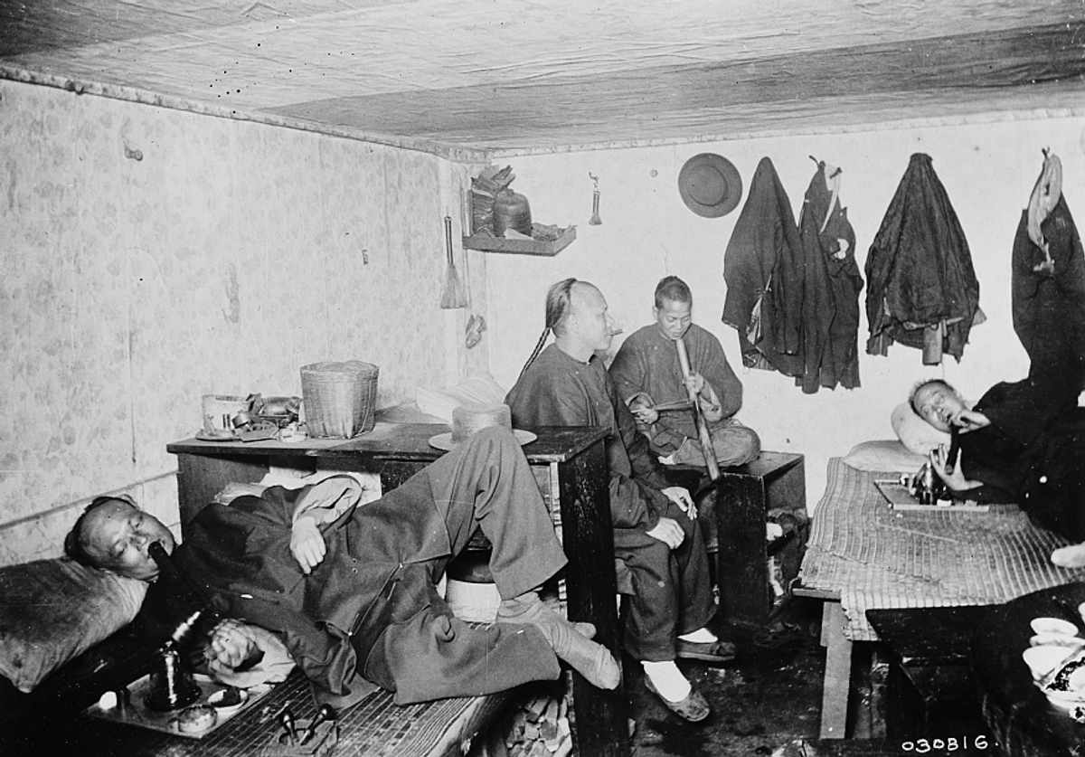 Real opium dens like this one, photographed some time between 1890 and 1910, loomed large in the popular imagination.