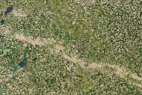 Hail scar through the green cornfields of South Dakota. 