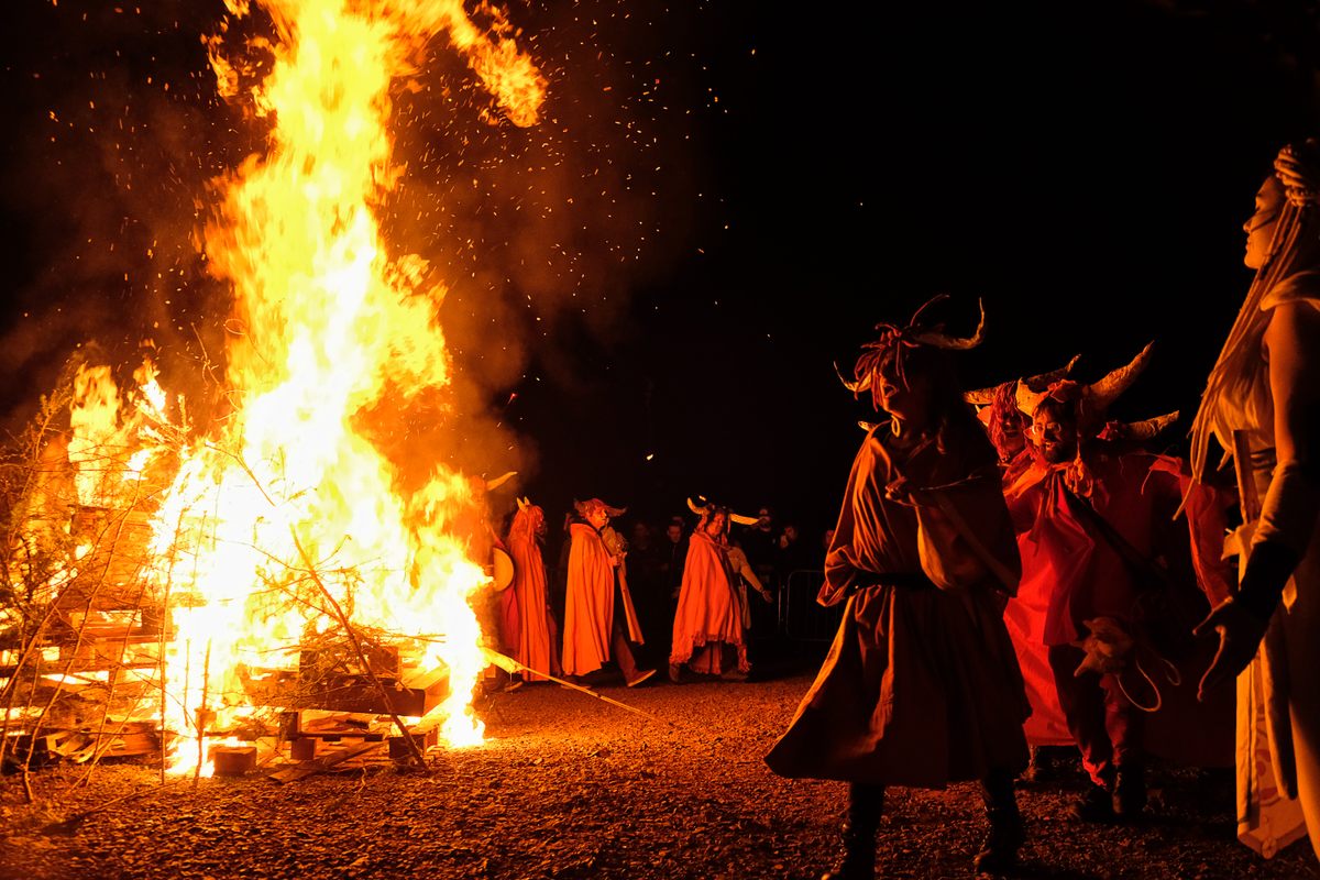 Performers beside the burning bonfire on Calton Hill.