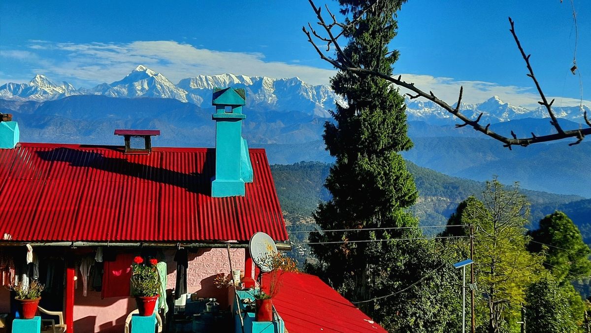 Kartik's red-roofed house looks over to the mountains in the Kausani district of the north Indian state of Uttarakhand.