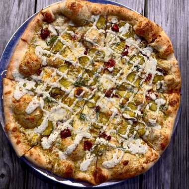 A “Hot Matty” pizza topped with pickles, house-made ranch, Calabrian chiles, dill, and so much cheese.