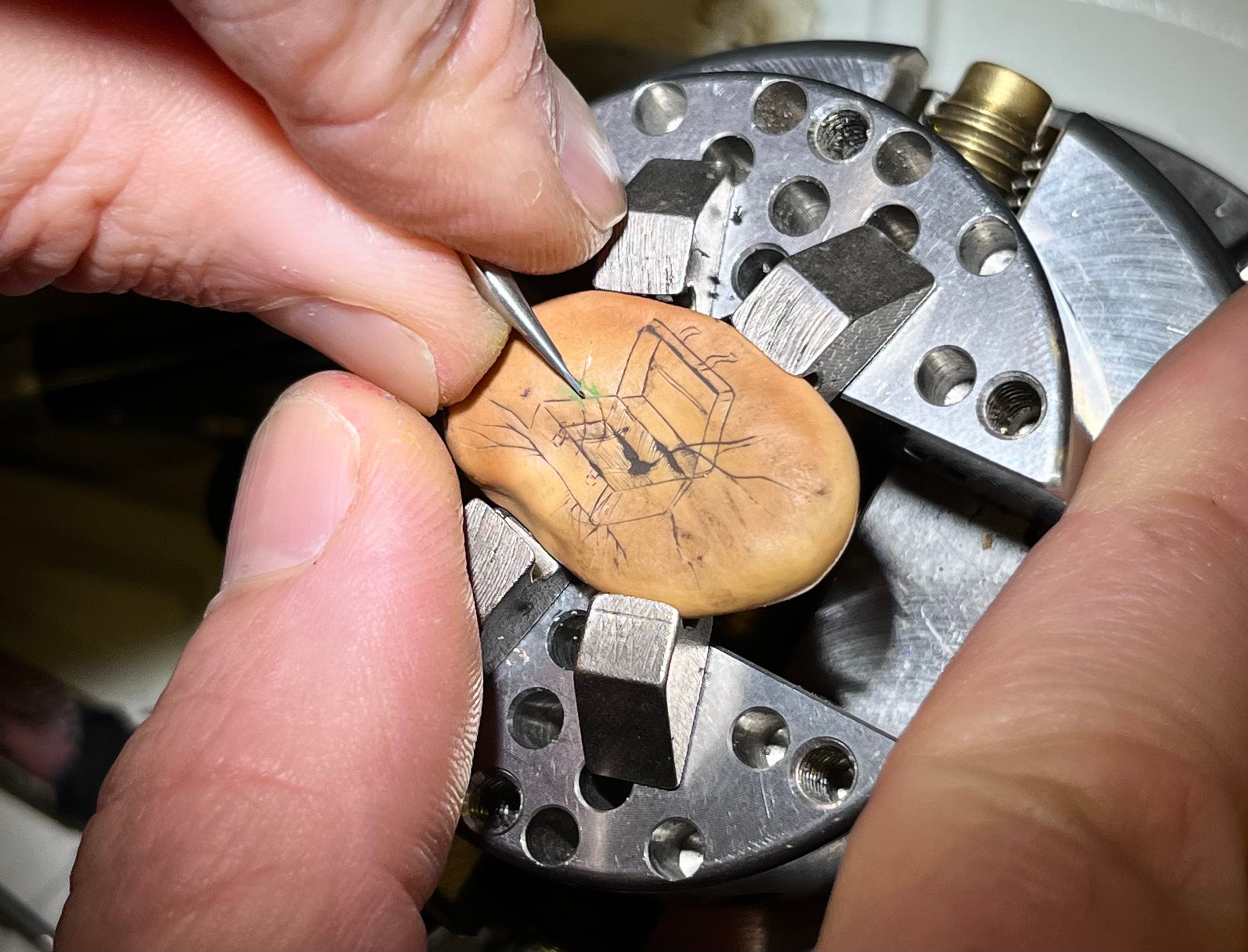 Artist Sergey Jivetin creating a seed carving at the New York Botanical Garden.