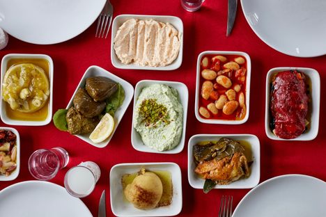 This spread of meze includes topik, dolma saraylı, bean pilaki, tarama, and artichoke.