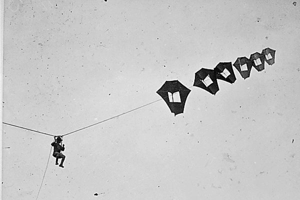 Lt. Kirk Booth of the U.S. Signal Corps being lifted skyward by a man-carrying kite.