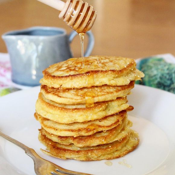 Cornmeal johnnycakes topped with honey.